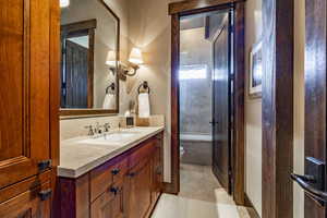 Bathroom with tile patterned flooring, vanity, and toilet