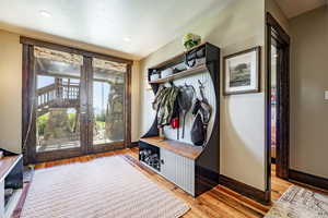 Mudroom with light hardwood / wood-style flooring