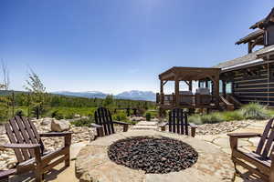 View of patio with a pergola, a deck with mountain view, and an outdoor fire pit