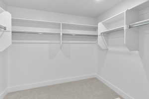 Walk in closet featuring carpet flooring