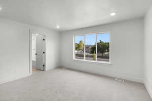 Unfurnished room featuring light carpet