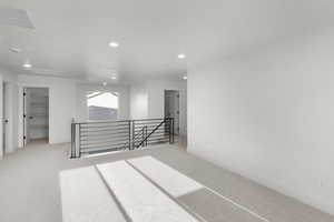 Unfurnished room featuring light carpet