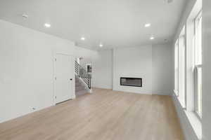 Unfurnished living room with light wood-type flooring