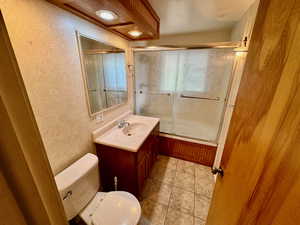 Bathroom with tile floors, toilet, and large vanity