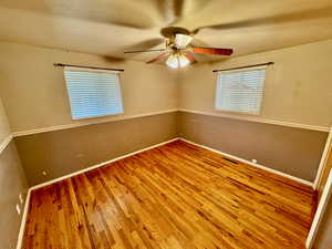 Empty room featuring wood-type flooring and ceiling fan