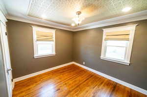 Unfurnished room featuring ornamental molding and hardwood / wood-style floors