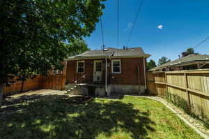 Rear view of property featuring a yard