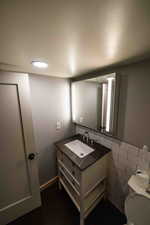 Bathroom featuring oversized vanity and tile walls