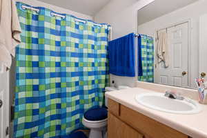 Bathroom featuring oversized vanity and toilet