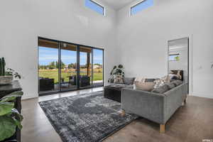 Living room featuring a towering ceiling and concrete floors