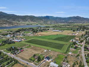 Birds eye view of property with a water and mountain view