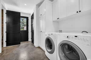 Laundry area featuring independent washer and dryer, cabinets, and hookup for a washing machine