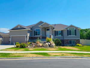 View of front of house with a garage and a front lawn