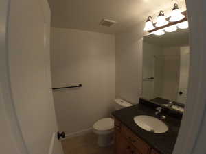 Hall bath Bathroom featuring tile floors, oversized vanity, and toilet