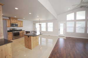 Kitchen featuring a kitchen island, stainless steel appliances, a wealth of natural light, and sink