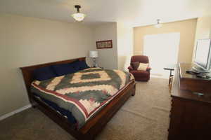 Bedroom featuring an ensuite bath, and a walk-in closet