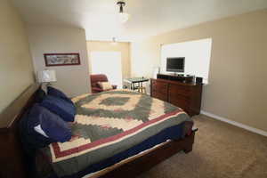 Bedroom featuring an ensuite bath, and a walk-in closet