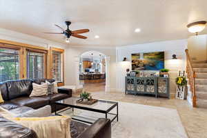 Family room with tile flooring, and ceiling fan