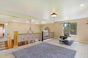 Loft featuring carpet flooring and coffered ceiling