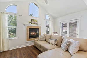 Bedroom Sitting Room featuring a healthy amount of sunlight, dark hardwood / wood-style floors, a tiled fireplace, and ceiling fan