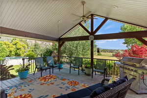 Backyard covered deck featuring outdoor lounge area, a swimming pool, and area for grilling