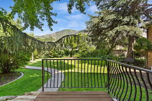 Deck with a yard and a mountain view