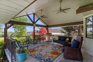 Backyard covered deck featuring ceiling fan and a gazebo