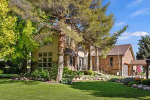 View of front of property featuring a garage and a front yard