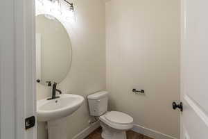 Bathroom featuring toilet and hardwood / wood-style flooring