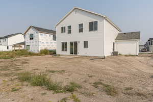 Back of house with central AC unit