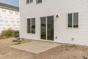 Rear view of property featuring a patio area