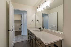 Bathroom featuring tile patterned flooring and vanity