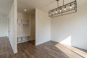 Unfurnished dining area featuring dark hardwood / wood-style floors