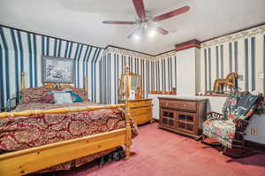 Carpeted bedroom featuring ceiling fan