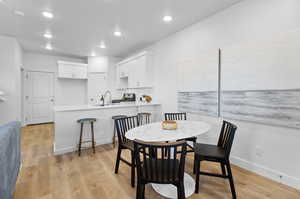 Dining room with sink and light hardwood / wood-style floors