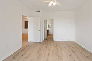 Empty room with light wood-type flooring and ceiling fan