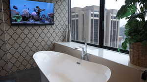 Bathroom with a soaking tub and tile floors