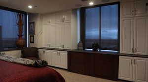 Bedroom featuring light colored carpet