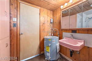 Utility room featuring sink and water heater