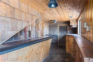 Kitchen with wooden ceiling and wood walls