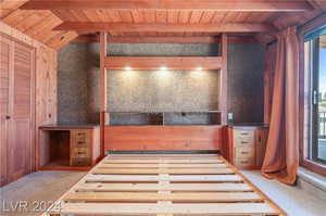 Kitchen featuring wooden ceiling, lofted ceiling with beams, and carpet floors