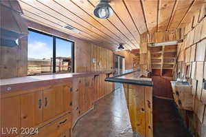 Kitchen with wooden ceiling and wood walls