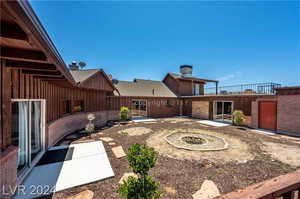 View of yard with an outdoor fire pit and a patio