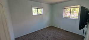 Unfurnished room with carpet flooring