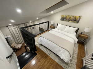 Bedroom with wood-type flooring