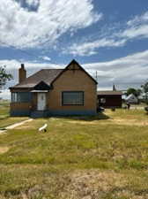 Single story home featuring a front lawn