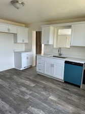 Kitchen with white cabinetry, sink, dark hardwood / wood-style floors, and dishwasher