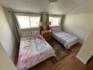 Bedroom with hardwood / wood-style flooring