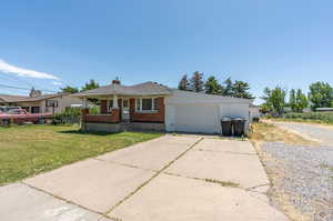 View of front of home with a garage and a front yard