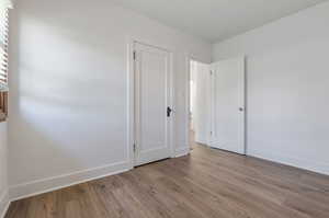 Empty room featuring wood-type flooring